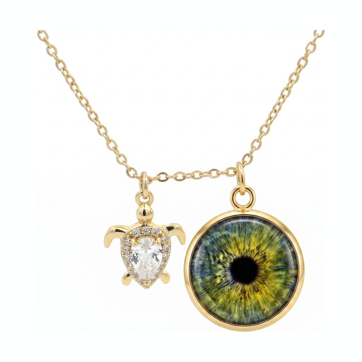 Eyeris Luxe necklace style G3 — custom iris pendant paired with a crystal sea turtle charm in gold.